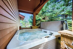 A hot tub with a wooden deck and a view of a forest. - 2430 Ultimate Deer Valley Getaway Hot Tub and 2 Gold  Utah Ski Passes (Park City)