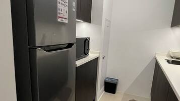 Fridge, microwave, electric kettle, cookware/dishes/utensils