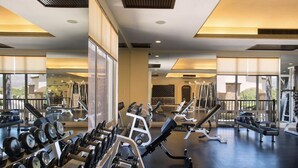 A gym with various exercise equipment, large windows, and a view of the outdoors. - Villa del Arco  Beach Front. Grocery store on site or short ride. Full Kitchen.  (Cabo San Lucas)