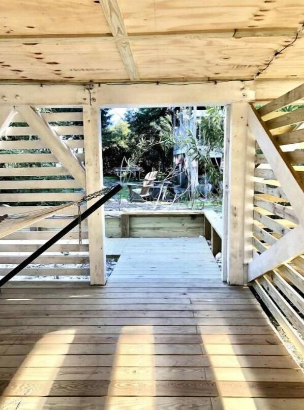 Relax in a serene outdoor space with a hammock and a central support beam.