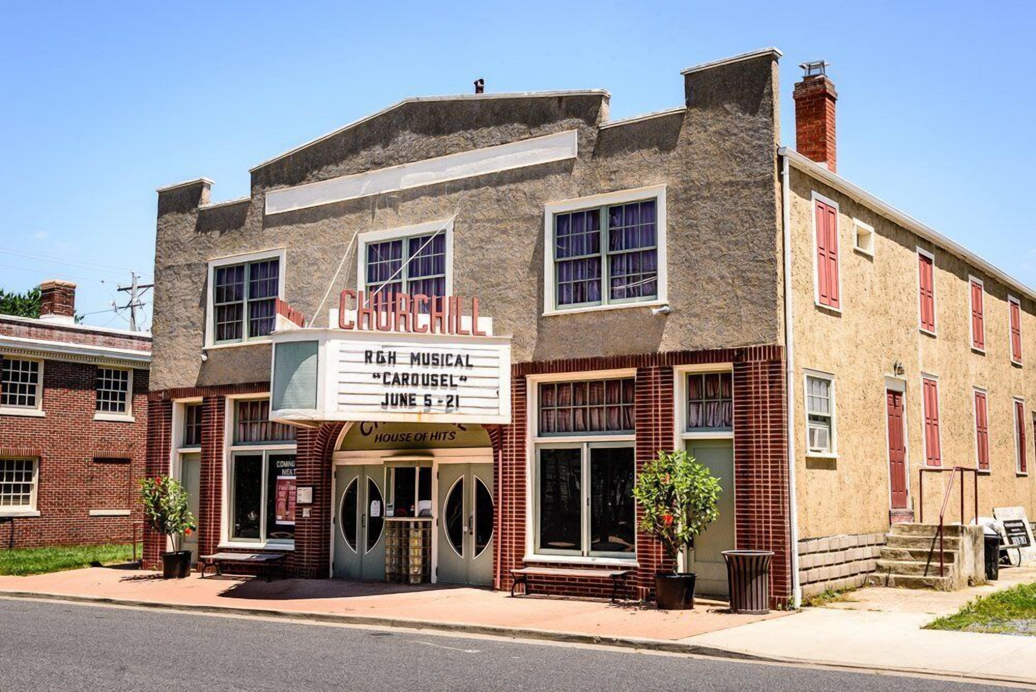 A historic building with a marquee advertising a musical event.
