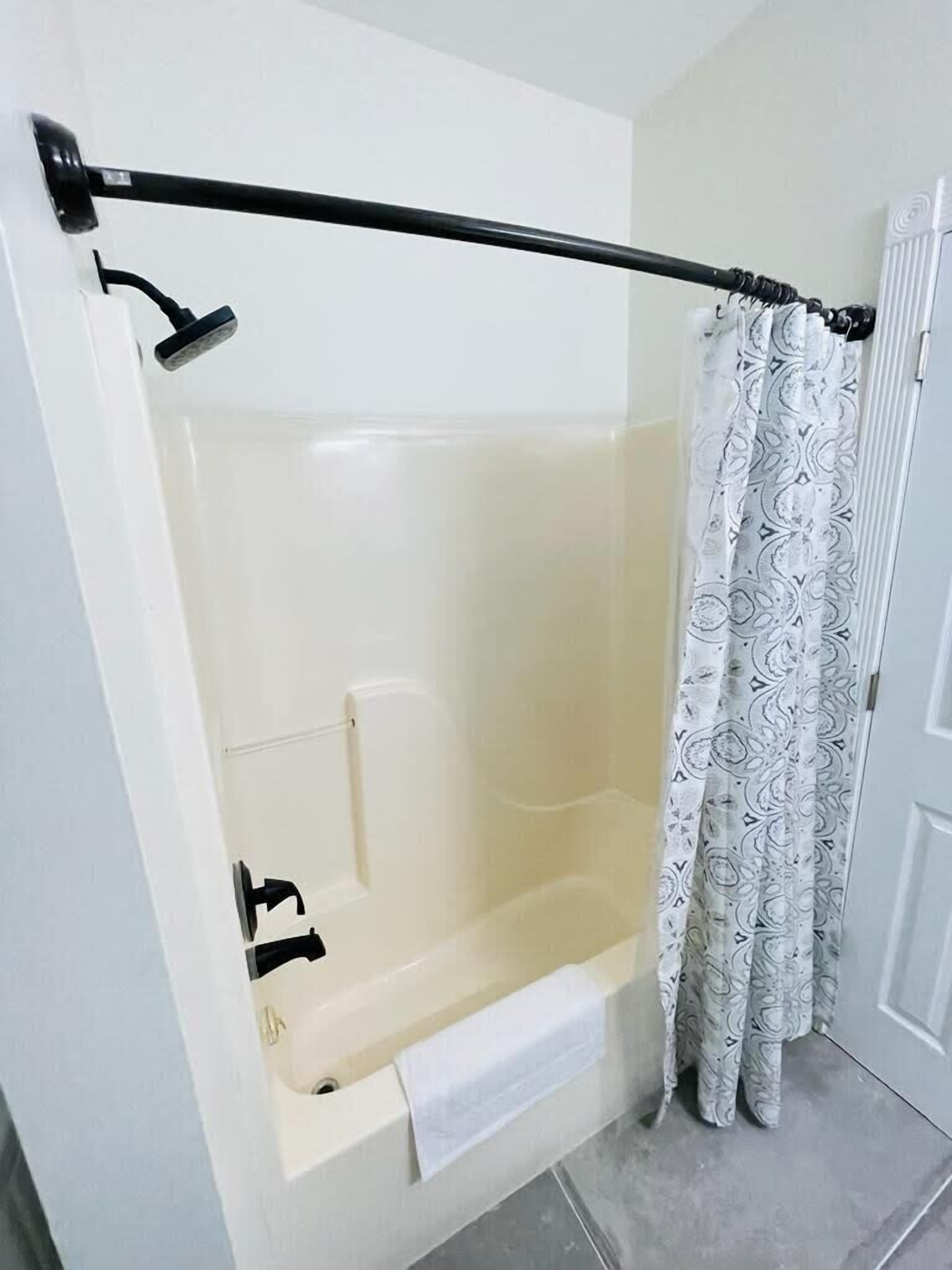 A bathroom with a bathtub, a shower, and a toilet.