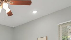 A bedroom with two single beds, a wooden nightstand, a ceiling fan, and a framed picture on the wall. - EADO 3BR Downtown Houston home (Houston)