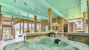 A hot tub area with wooden beams and a sign reading "Casa Crystal." - Casa Crystal - Relax and create unforgettable memories (Bolivar Peninsula)