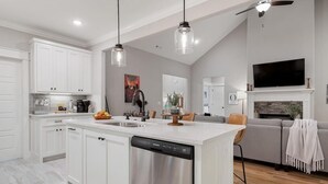 A modern kitchen with white cabinetry, a dishwasher, and pendant lighting. - "THE ODIN" off the OZ TRAIL (Bella Vista)