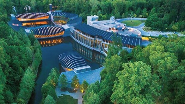 An aerial view of a hotel with multiple interconnected buildings, surrounded by dense forest. - "THE ODIN" off the OZ TRAIL (Bella Vista)