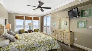 A bedroom with a bed, a dresser, a television, and a view of the ocean. - 🏖️ Luxury Oceanfront Retreat • Steps to Boardwalk • Rooftop Pool + Parking 🏖️ (Ocean City)