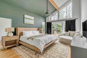 A modern bedroom with a bed, bedside tables, a sofa, and large windows. - Sunlight Chalet, Ultimate Highlands Destination (Highlands)