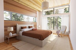 Relax in this serene bedroom with a large bed, nightstand, and comfortable chair.