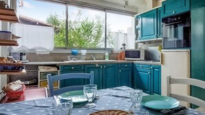 A kitchen with teal cabinets, a microwave, and a refrigerator. - 2 bedroom gorgeous home in St-Georges-de-Didonn (St-Georges-de-Didonn)