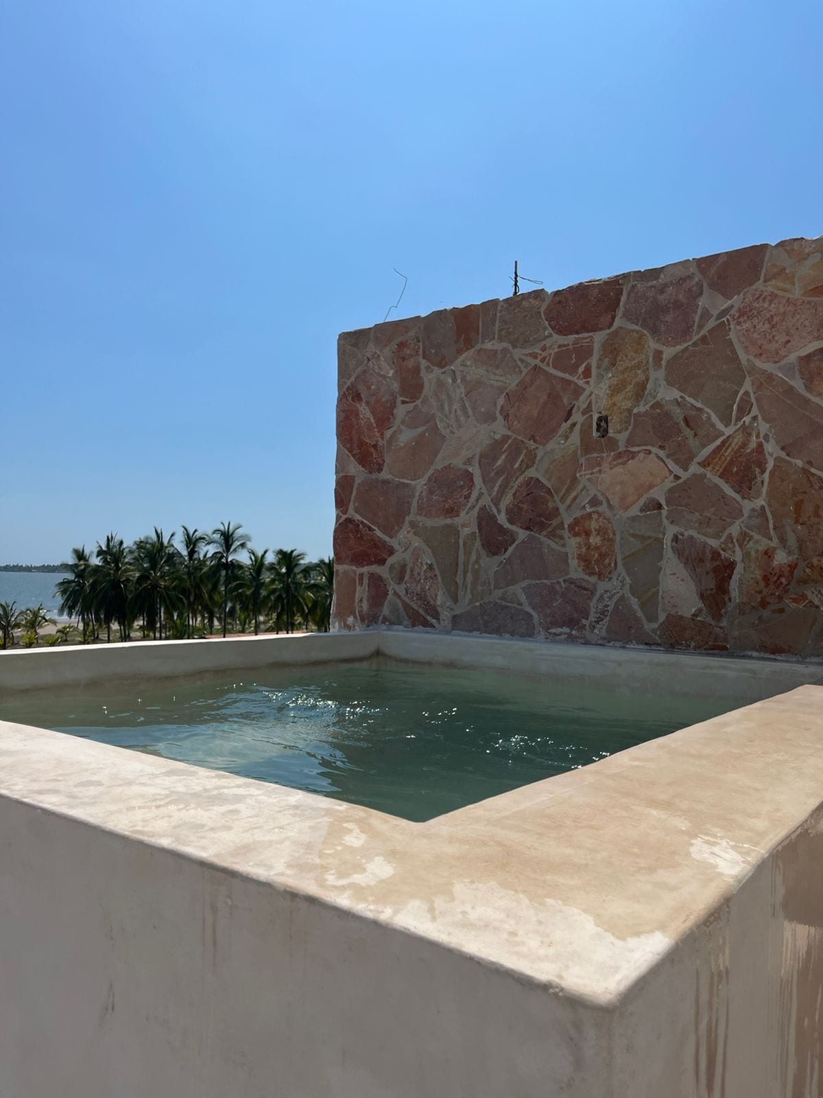 A stone wall with a pool.