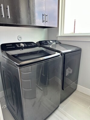 Efficient laundry facilities with a front-loading washer and dryer.