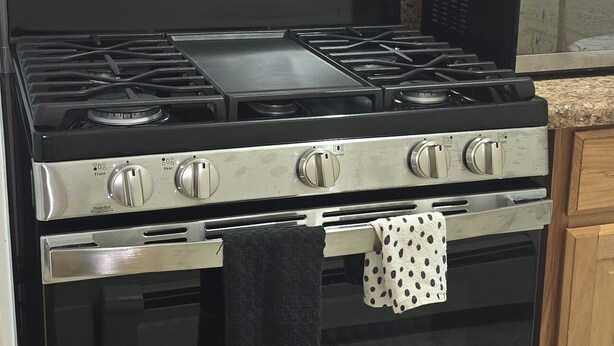 A kitchen with a stainless steel stove, oven, and a microwave on the countertop. - Cozy, yet spacious studio apt. (Hibbing)
