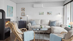 A cozy living room with a fireplace, a sofa set, and a dining table. - "Werna" - 900m from the sea by Interhome (Pandrup)