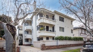 A multi-story residential building with balconies, a brick lower level, and a white upper level. - Pet Friendly - Charnwood Charm in St Kilda (St Kilda)