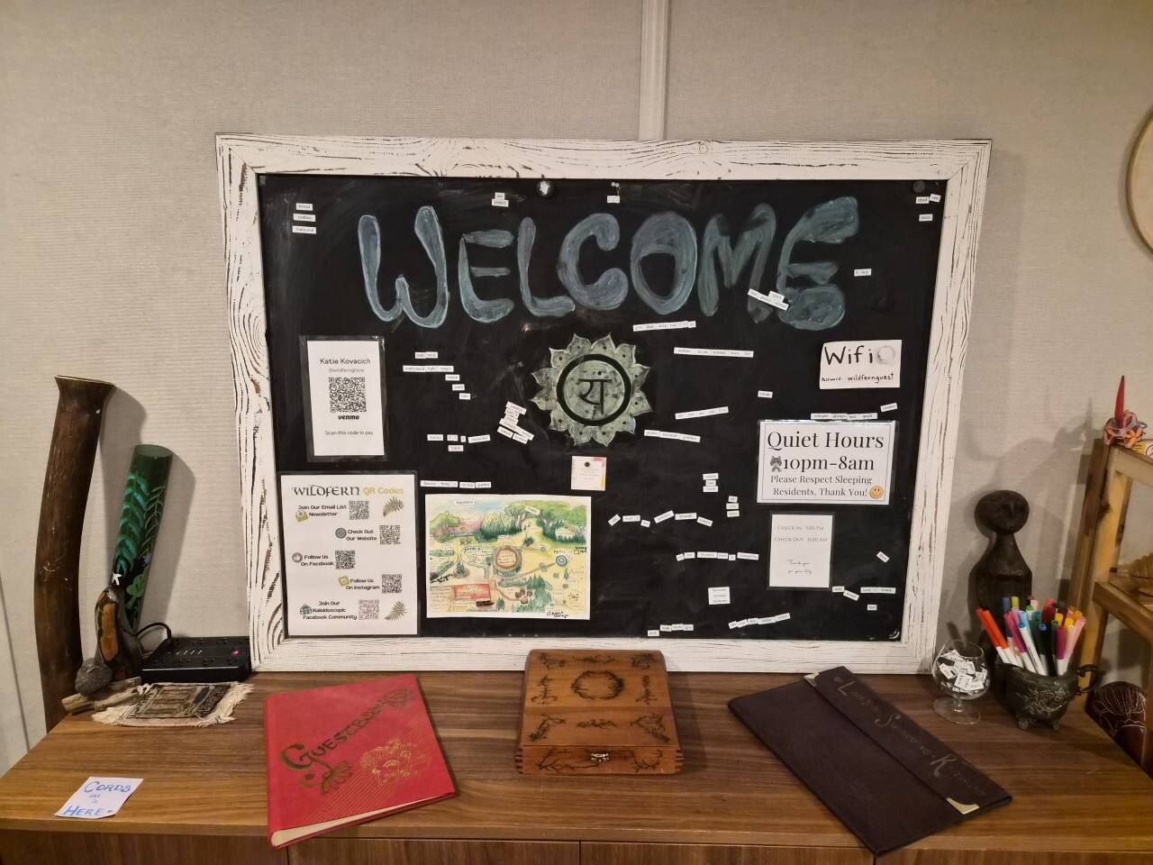 A bulletin board with a 'WELCOME' sign, a clock, and various informational cards including WiFi details and quiet hours.