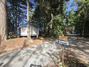 A sign indicating a parking area named 'Soul' with a camping trailer in the background.