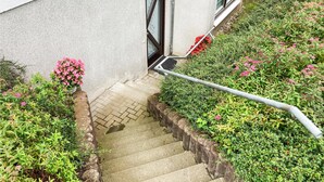 Un escalier en béton mène à une porte portant une plaque avec le numéro « 40 ».