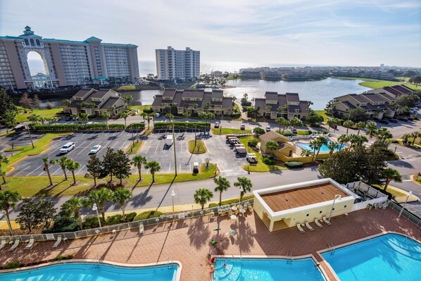 A resort with multiple buildings, a parking lot, and a swimming pool area.