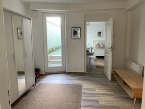 Relax in this spacious room with a large bed, bedside table, and comfortable chair.