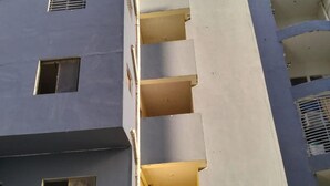 A multi-story building with visible balconies and windows.
