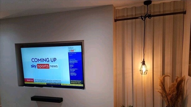 A flat-screen TV mounted on a wall displaying 'Sky Sports News'. - Remarkable 3-bed House in Chelmsford (Chelmsford)