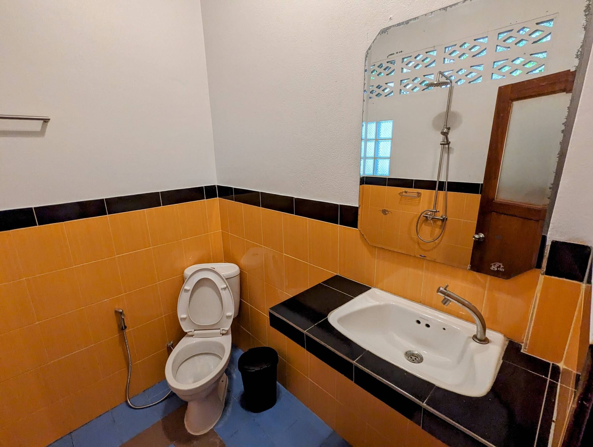 A bathroom with a toilet, sink, and shower.