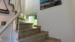 A staircase with stone steps leading to a landing.