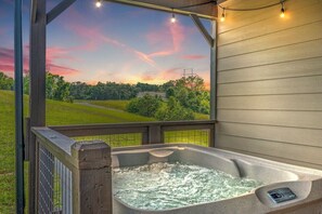 A hot tub with a view of a sunset over a green landscape. - Free Dollywood Tix/HotTub/FirePit/Peaceful/Arcade/ (Sevierville)