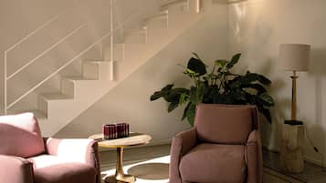 Luxury Suite | Living area | 0-inch LCD TV with digital channels, first-run movies, printers