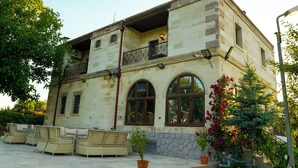 A two-story building with a stone facade, arched windows, and a balcony. - Cevizli Konak (Nevsehir)