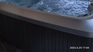 A hot tub with a wooden cabinet and a window. - La Chèvrerie (Taintrux)