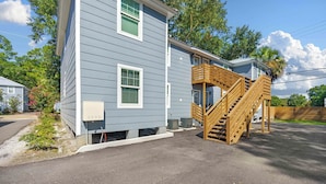 A two-story house with a wooden staircase leading to the second floor. - The Tulip in Midtown (Mobile)