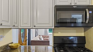 A kitchen with white cabinets, a microwave, a Samsung oven, and a granite countertop. - 4BR House near Casinos & Beach With In Law Suite (Preston)