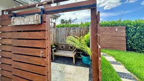 A wooden pergola with a sign reading "Beach House" and a bench underneath. - Waterfront Oasis – Private Heated Pool & Waterfall Hot Tub (Pompano Beach)