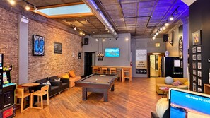 A cozy indoor space with a pool table, seating area, and a billiards table.