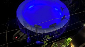 A large, illuminated blue structure, possibly a decorative feature or part of an exhibit. - Bungalow Avec vue Dans Lieu Calme (Le Carbet)