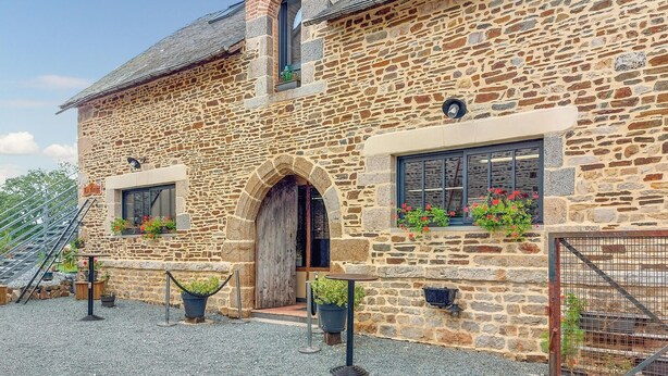 A stone building with a wooden door, potted plants, and a sign reading "La Forge". - Cozy home in Neuilly le Vendin with WiFi (Neuilly le Vendin)