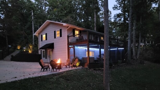 A two-story house with a covered porch and a fire pit. - 3 LITTLE BEARS DEN AT BEAR PAW
GREAT FAMILY VACATION HOME. EVERYTHING YOU NEED (Murphy)