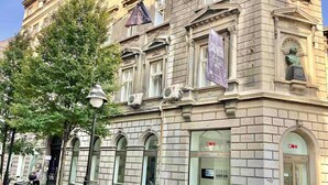 A historic building with arched windows and a statue on the facade. - Belgrade heart of historical center (Belgrade)