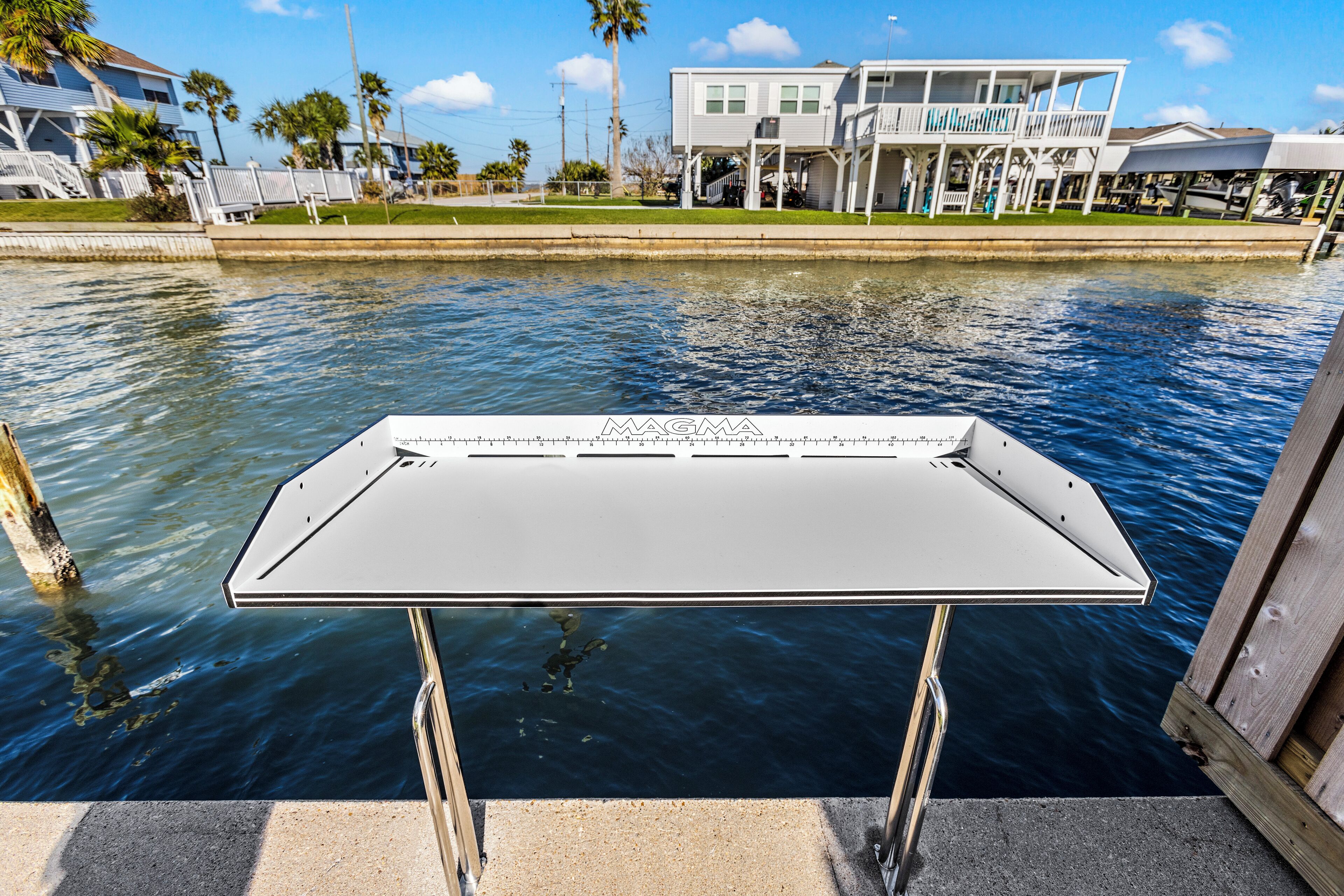 A boat dock with a metal railing and a white table in the foreground.
