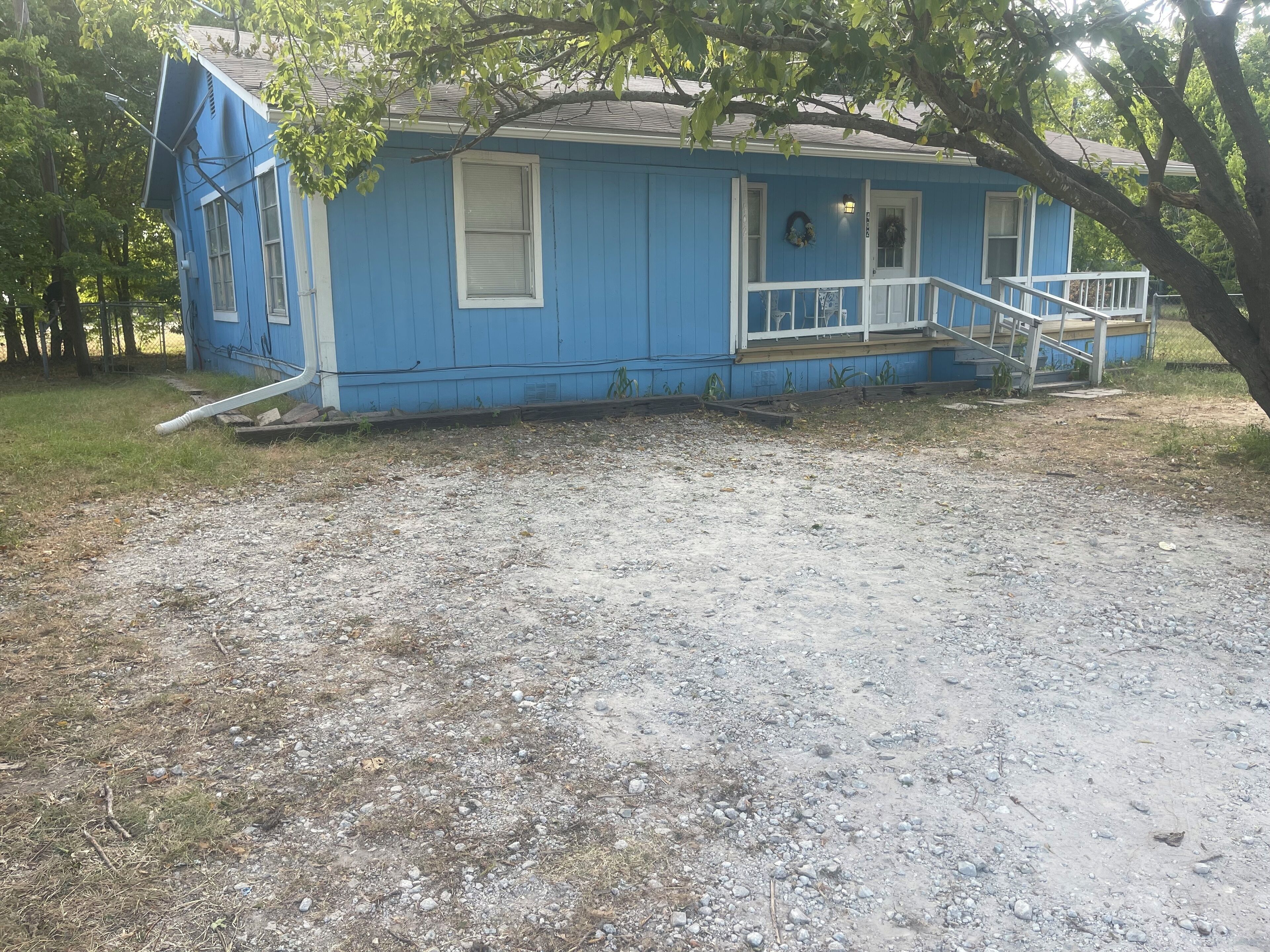 A blue house with a porch and steps.