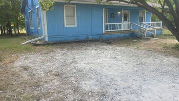 A blue house with a porch and steps.
