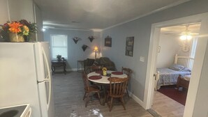 A compact living space with a kitchen, dining area, and a bedroom. - Blue Pool House  (Lone Oak)