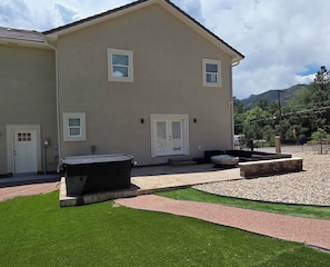 A two-story building with a flat roof, a front door, and two windows with shutters.