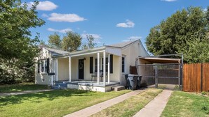 A single-story house with a covered porch, a fenced backyard, and a clear sky. - Cozy two bedroom home in Amarillo. Pet Friendly! (Amarillo)