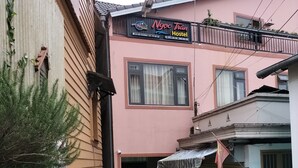 A narrow alleyway between buildings with a hostel sign above. - Ngoc Tran Hostel (Cam Ly - Da Lat)