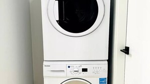 A white stacked washer and dryer unit with control panels and a "Energy Star" label.