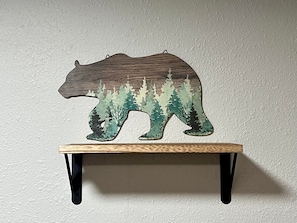 A wooden bear-shaped shelf with a forest scene on a wall. - Log cabin in heart of Anchorage (Anchorage)