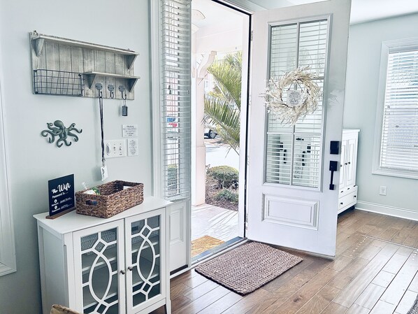 A modern interior with a wooden cabinet, a basket, and a door leading outside.